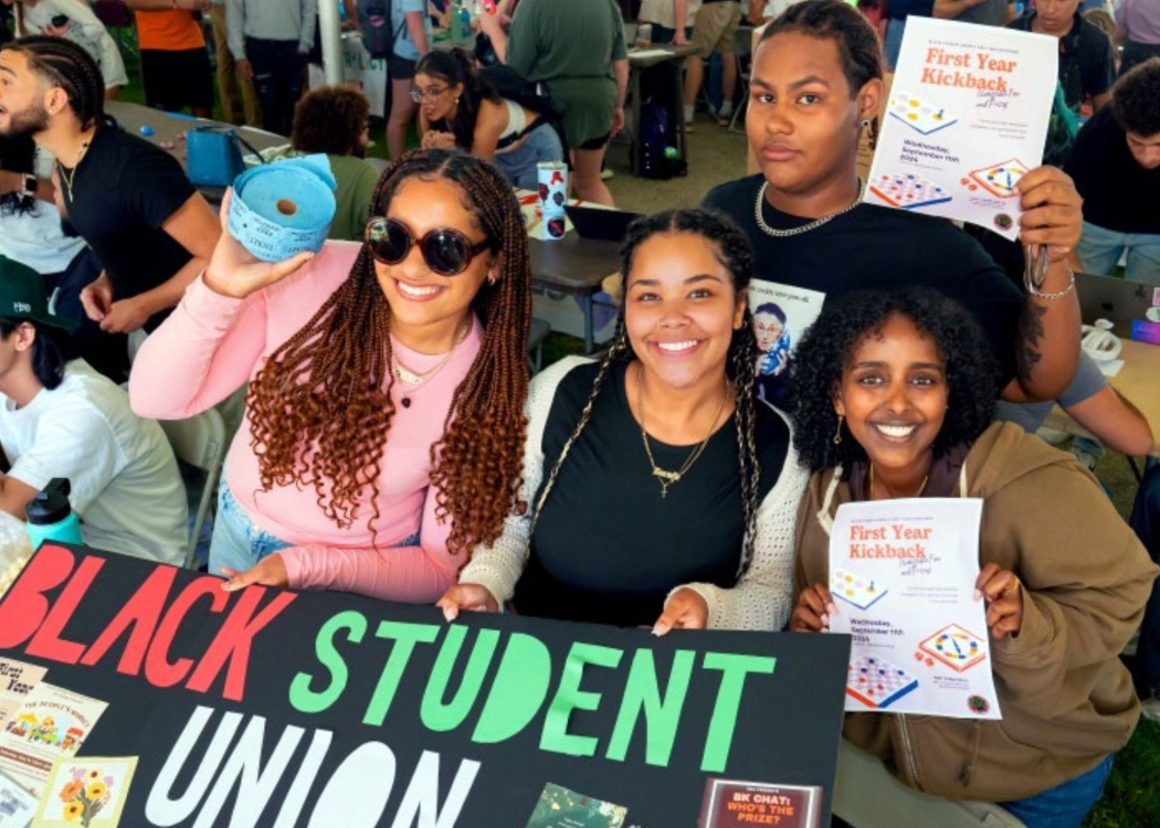 Students at Club Expo holding a Black Student Union Poster