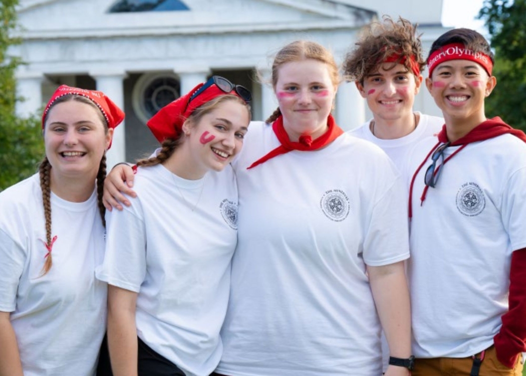 Students dressed in spirited clothing smiling in a row