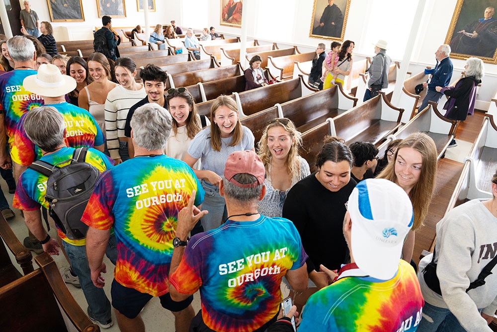 Students warmly greet alumni attending Reunion in Memorial Chapel.