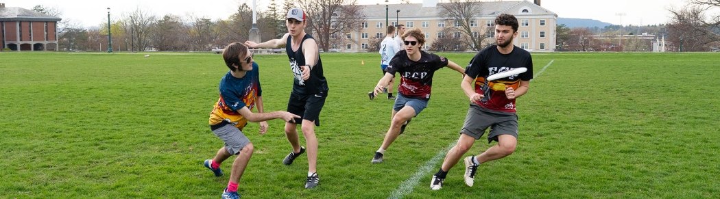 Competitive frisbee on the campus lawn