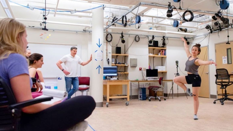 Student dancing in the lab while tests are conducted on motion