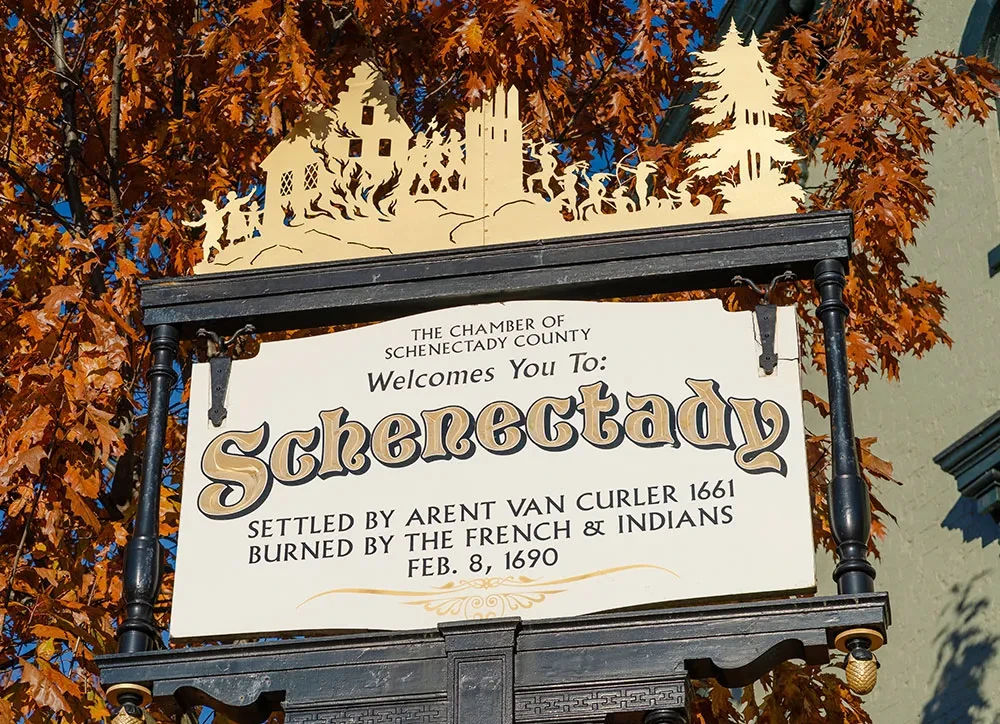 A sign welcoming visitors to Schenectady includes references to the massacre.