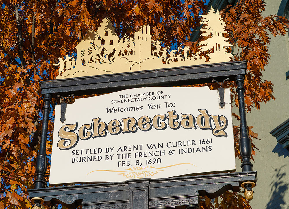 A sign welcoming visitors to Schenectady includes references to the massacre.