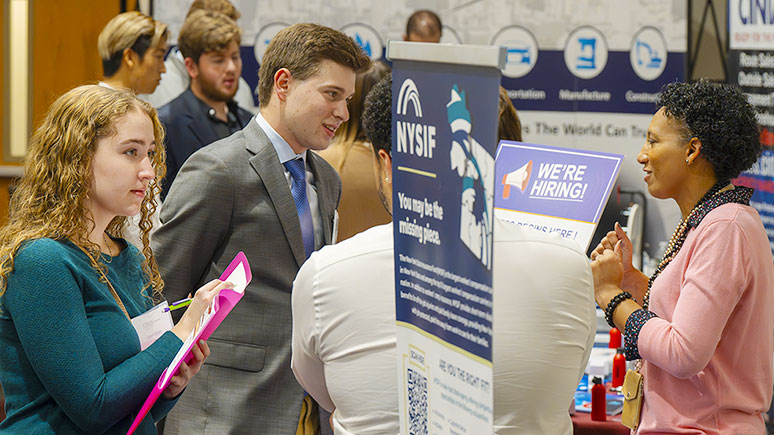 Two Union students speak with a representative from a local employer at the college’s annual career fair.