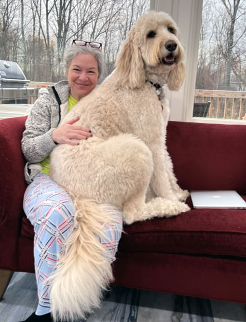 Judith Lewin, associate professor of English and chair of the department, with her Bernedoodle, Callie. 