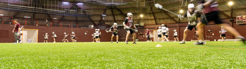 Members of the men’s lacrosse team practice on the new indoor turf facility.