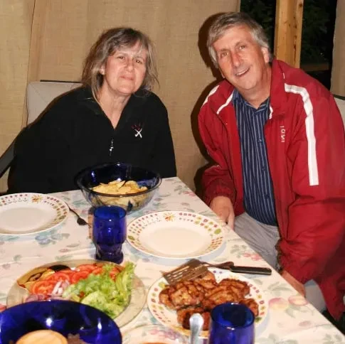 Stephen Schmidt, the Kenneth B. Sharpe Professor of Economics, and his wife, Alexandra, in their sukkah.