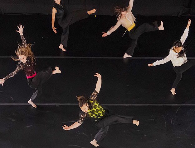 Energetic dancers perform a routine before a full-capacity crowd in the Nott Memorial.
