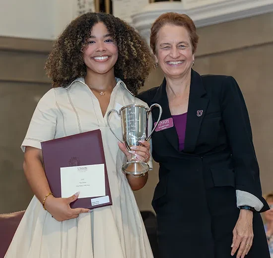 President Elizabeth Kiss presents Dani Brown ’26 the Frank Bailey (1885) 