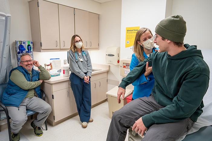 Dr. Jamie Flerlage ’05, division chief for pediatric hematology/oncology at the University of Rochester’s Golisano Children’s Hospital, checks over her patient, Jack Dyson.
