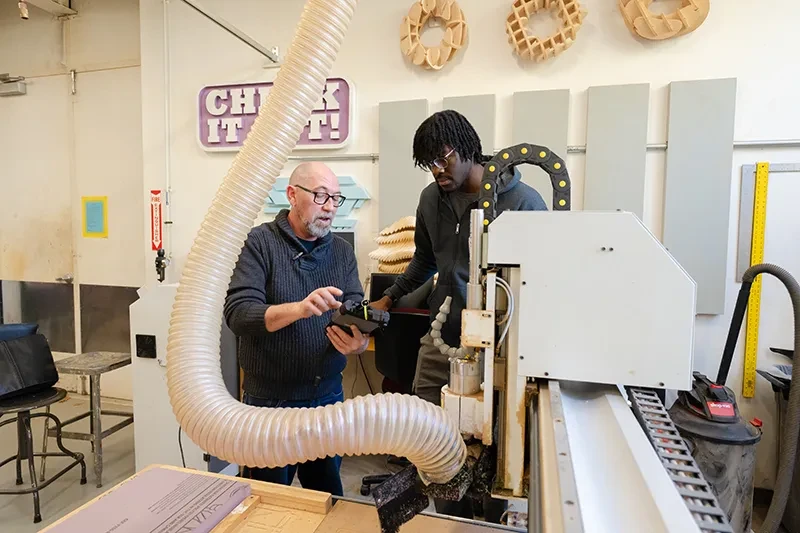 On a recent weekday afternoon, Cole Belmont, Union’s Makerspace director, stood beside a CNC router (computer numerical control) in a lab in the Feigenbaum Center for Visual Arts. Enoch Fashola ’30, a mechanical engineering major from Houston, listened intently as Belmont explained how they were going to use the automated, computer-driven cutting and milling machine to create three-dimensional tiles for display in the lab. “We can make complex, precise cuts with this,” Belmont said. “It opens up a whole ran