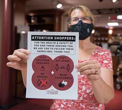 Staff member holding a sign in the bookstore