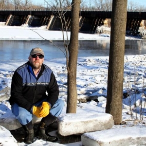 John I. Garver outside by a river in winter 