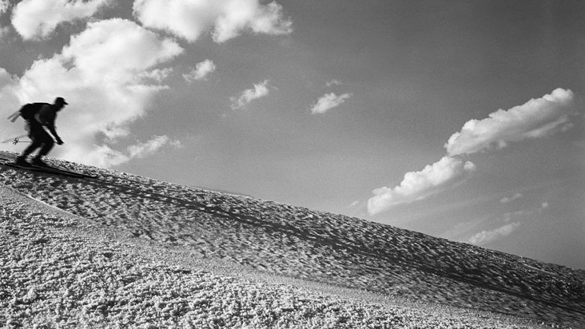 Flickinger Collection: Chet Rice on Marcy The Big Drift 5/10/1953. Man skiing rapidly down hill.