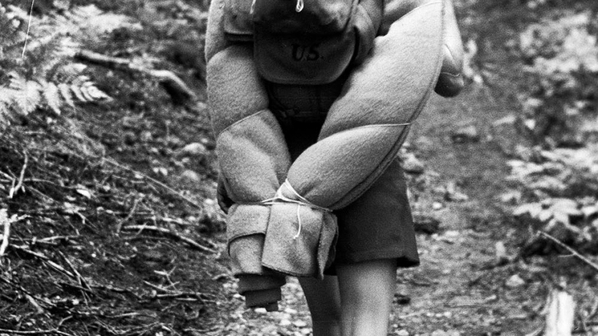 Flikinger Collection: Kay Flickinger Dockstader hiking with bedroll. Woman hiking mountain trail with large backpack.
