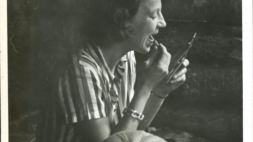 Flickinger Collection: Kay Flickinger Dockstader putting on lipstick Woman puts on lipstick in forest campsite