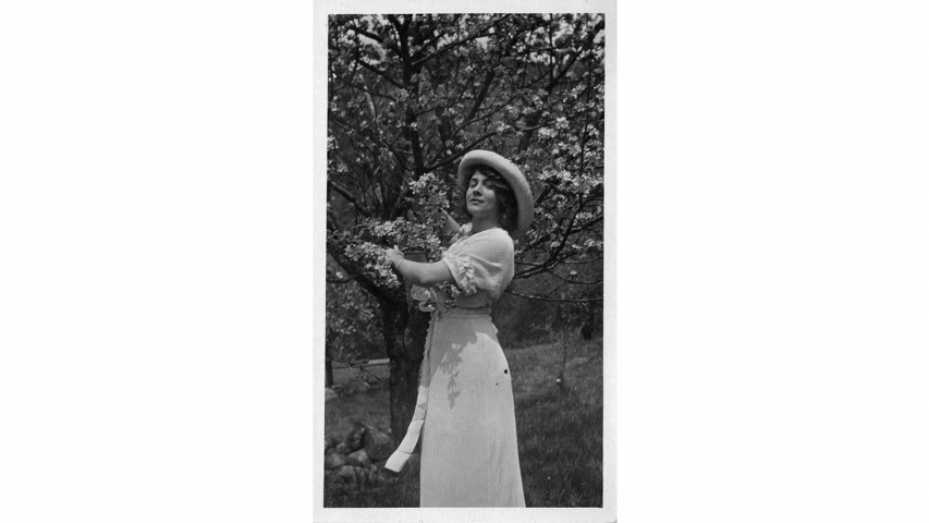 Jeanne Robert Fosters holds a flowering spring branch