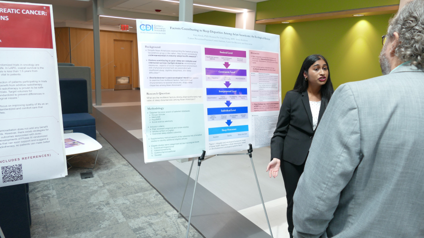Aleena Kuriakose 27' presenting her research to a faculty member at the 1st annual Combined Degree Student Research symposium