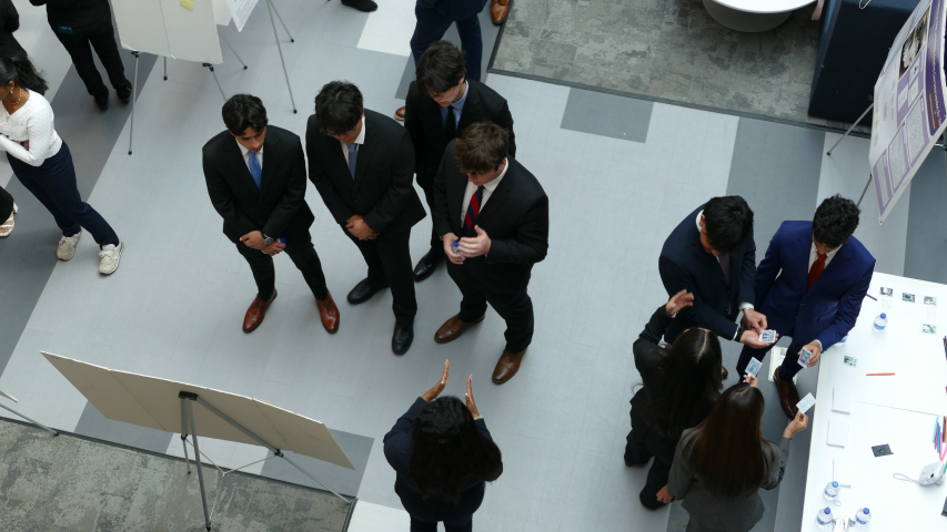 A picture of students presenting and participating in an ice breaker exercise at the 1st annual Combined Degree Student Research symposium