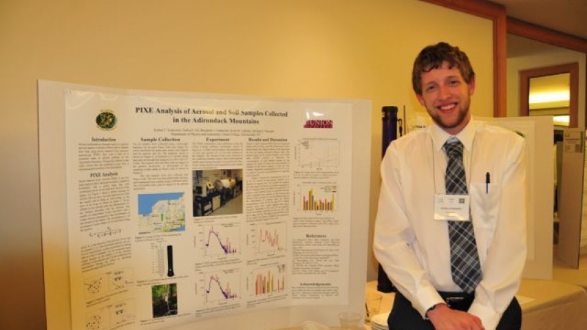 Josh Yoskowitz next to poster at the 4th Joint Meeting (2014) of the Nuclear Physics Division of the APSn