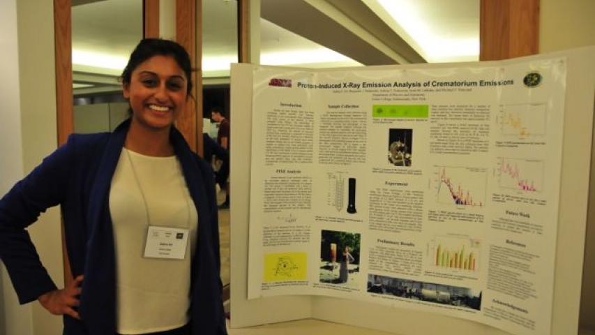 Salina Ali next to poster at the 4th Joint Meeting (2014) of the Nuclear Physics Division of the APS