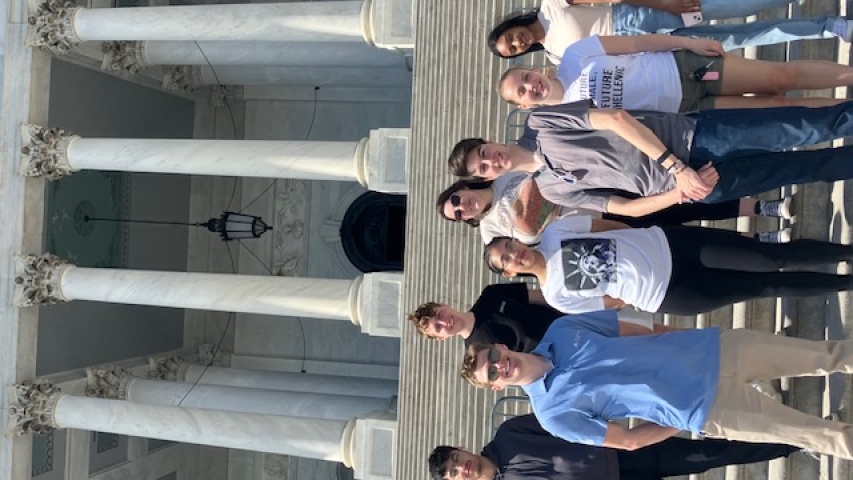 A group of 8 students standing on the steps of a building in Washington DC