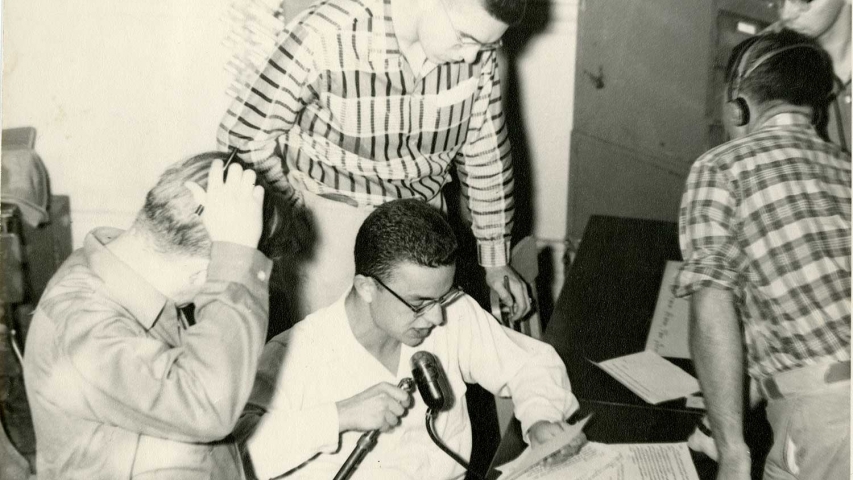 Archival photo of students looking at radio equipment