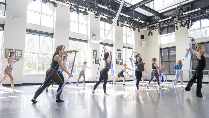 Dance students use resistance bands.