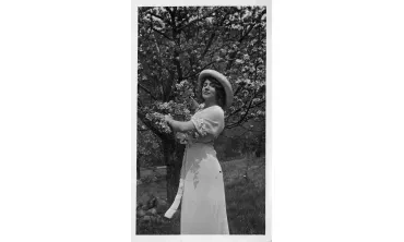 Jeanne Robert Fosters holds a flowering spring branch