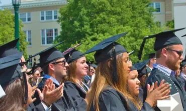 Graduates clapping at Commencement