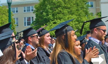 Graduates clapping at Commencement