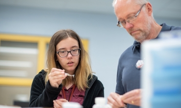 Michael Vineyard, the Frank and Marie Louise Bailey Professor of Physics, works in the lab with Mia Villeneuve '22, a physics major with a minor in theater. Villeneuve is part of a program that supports the recruitment and retention of women and underrepresented groups in all STEM disciplines.