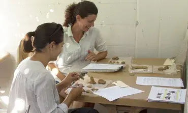 Dr. Angela Commito and University of Michigan Ph.D. student Christina Di Fabio record pottery collected in different survey units across the site.