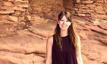 Laini Nemett in front of cliff dwellings in Cedar Mesa, Utah