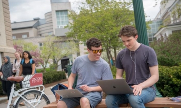 Students looking at their laptops.