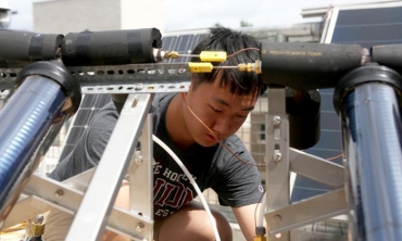 Sunan Sun ‘20 works on the roof of Wold Center as part of his research learning about the applications of solar energy.