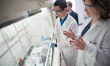 Mary Carroll ’86, the Dwane W. Crichton Professor of Chemistry in the aerogel lab with a student.