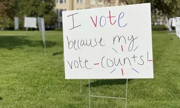 A campus sign encouraging students to vote
