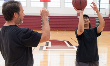 Jonathan Marr, senior lecturer in physics and astronomy, works with Genesis Santana ’21 on her shooting technique. For her summer research project, Santana is learning how the principles of physics apply to the science of basketball.