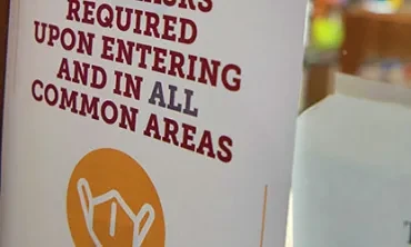 A sign saying that face masks are required in all common areas