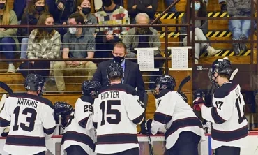 Men's hockey coach Rick Bennett talks with his players during a recent game.