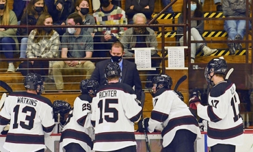 Men's hockey coach Rick Bennett talks with his players during a recent game.