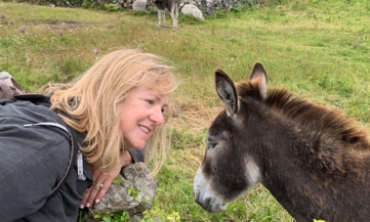 Joan Thompson loves to travel. Here, she's trying to befriend a donkey in Inishmore, Ireland.