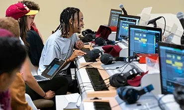 STS students working in classroom with keyboards, monitors and microphones