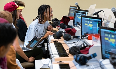 STS students working in classroom with keyboards, monitors and microphones