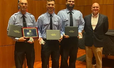 At their recent graduation from the Zone 5 Regional Law Enforcement Training Center program, from left, Officers Peter Parker, Corey Compositor and Adam Blanc are joined by Scott Jones, vice president for administration and finance. Officer Parker graduated as class leader.