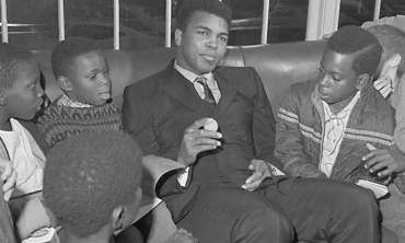 Muhammed Ali jokes with local fourth-graders at Phi Sigma Delta's House.