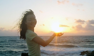 Jue (Joy) Wang enjoys sunrise in Isla Mujeres, where the sun's rays touch Mexico for the first time.