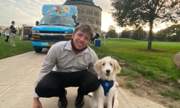 Mark Yetman with a dog in front of the Nott Memorial