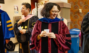 Stacie Raucci, the Frank Bailey Professor of Classics and chair of the department, mingles with colleagues in the lobby of Yulman Theater as they prepared to robe before Convocation. Raucci is the new College Marshal.